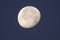 Beautiful waning gibbous moon against a dark blue night sky