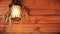 Beautiful warm cozy background warming the soul. Glowing lantern on the wall of a wooden house. Village hut. A bouquet