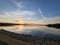 Beautiful warm sunset over the tranquil rocky shore