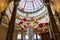 A beautiful water fountain with statues, tall pillars, Chinese lanterns and lush green plants at The Venetian Resort and Hotel