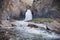 Beautiful waterfall 3 parrots in Kyrgyzstan.