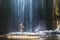 Beautiful waterfall in Bali, woman in bikini bathing