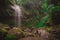 Beautiful waterfall in Boquete part of Panama called the hidden waterfalls. Beautiful jungle setting with lush greens and big moss