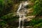 Beautiful waterfall called `Cascatinha Taunayon` on green nature in the Atlantic Rainforest, Tijuca Forest National Park