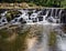 Beautiful waterfall cascades over rocks in forest