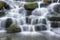 Beautiful waterfall cascades over rocks in forest