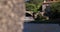 Beautiful waterfall flowing under old medieval bridge in rural Portugal. Slider reveal shot.