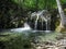 Beautiful waterfall with natural pool in the mountin forest. Exotic cascading river on Crimean mountains at spring, tourist place