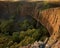 Beautiful waterfall over cliff at sunset