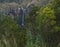 Beautiful waterfall Salto da Farinha falling from rocks in lush green rainforest vegetation, Sao Miguel, Azores