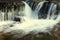 Beautiful waterfall with silky water. Magnificent wild landscape. Close-up