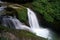 Beautiful waterfall on the way trekking to Annapurna base camp - green natural forest scene at annapurna national park Nepal