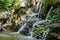 The beautiful waterfalls, rapids and mountain streams in the tropical forest in Yanoda Park,  Sanya city. Hainan, China