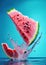 Beautiful Watermelon splash in blue background, water drops