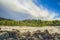 Beautiful waterscape with white moving cloud and waterfall from uphill in majestic outdoor in northern europe