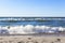 A beautiful wave hits the beach on a sandy beach on a Sunny day