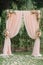 Beautiful wedding archway. Arch decorated with peachy cloth and flowers