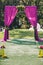 Beautiful wedding archway. Arch decorated with purple cloth and lemon