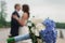 Beautiful wedding bouquet on the background of newlyweds