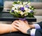 Beautiful wedding bouquet in brides and grooms hands