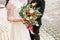 Beautiful wedding bouquet in hands of the bride