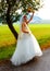 Beautiful wedding bouquet in hands of the bride, in Nature, Landscape background.