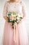 Beautiful wedding bouquet in hands of the bride. Rose, pink and Peach. Trendy and modern wedding flowers. Woman in wedding dress