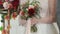 beautiful wedding bouquet in hands of bride at wedding celebration. close up view of flowers in red, pink, white