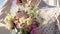 beautiful wedding bouquet in hands of unrecognizable bride at wedding celebration. close up view of flowers in pink