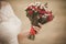 Beautiful wedding bouquet of red roses flowers in hand of anonymous young bride