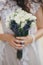 Beautiful wedding bouquet of roses and lavender in stylish bride hands on background of sunny street. Provence wedding. Bride