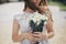 Beautiful wedding bouquet of roses and lavender in stylish bride hands on background of sunny street. Provence wedding. Bride