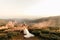 Beautiful wedding ceremony in the mountains, wedding couple of newlyweds in love hug and smile, wedding in nature