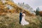 Beautiful wedding couple on idyllic pastoral landscape with rocks and fence as backround