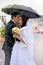 Beautiful wedding couple kissing in the rain. Bride and groom
