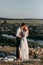 Beautiful wedding couple in nature in boho style. Wedding in the European style of fineart at sunset.