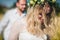 Beautiful wedding couple walking on field, bride and groom posing on wheat field with blue sky