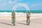 Beautiful Wedding Decor Arch with Flowers and Just Married Sign on an Ocean Deserted Coast. 3d Rendering