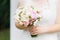 Beautiful wedding delicate wedding bouquet in the hands of the bride