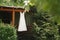 Beautiful wedding dress hangs on a wooden gazebo next to an outdoor Christmas tree.