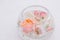 Beautiful wedding floral decoration in glass on a table in a restaurant. White tablecloths, bright room, candles, close-up shootin