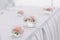 Beautiful wedding floral decoration in glass on a table in a restaurant. White tablecloths, bright room, candles, close-up shootin