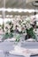 Beautiful wedding flowers decorate the table at the wedding banquet. Luxury wedding decor