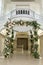 Beautiful wedding huppah decorated with fresh fresh flowers from hydrangea and eucalyptus sheets in a large beautiful wedding hall