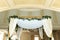 Beautiful wedding huppah decorated with fresh fresh flowers from hydrangea and eucalyptus sheets in a large beautiful wedding hall