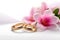 Beautiful wedding rings on a light background, which are adorned with flowers. Rings are a symbol of marriage and love.