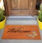 Beautiful welcome peach color coir doormat with Butterfly Placed outside door