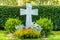 Beautiful and well cared grave with white marble cross