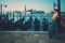 Beautiful well-dressed woman standing near San Marco square with gondolas and Santa Lucia island on the background.