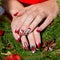 Beautiful well-groomed hands of a young girl with long fake acrylic nails with a festive Christmas pattern on the nails